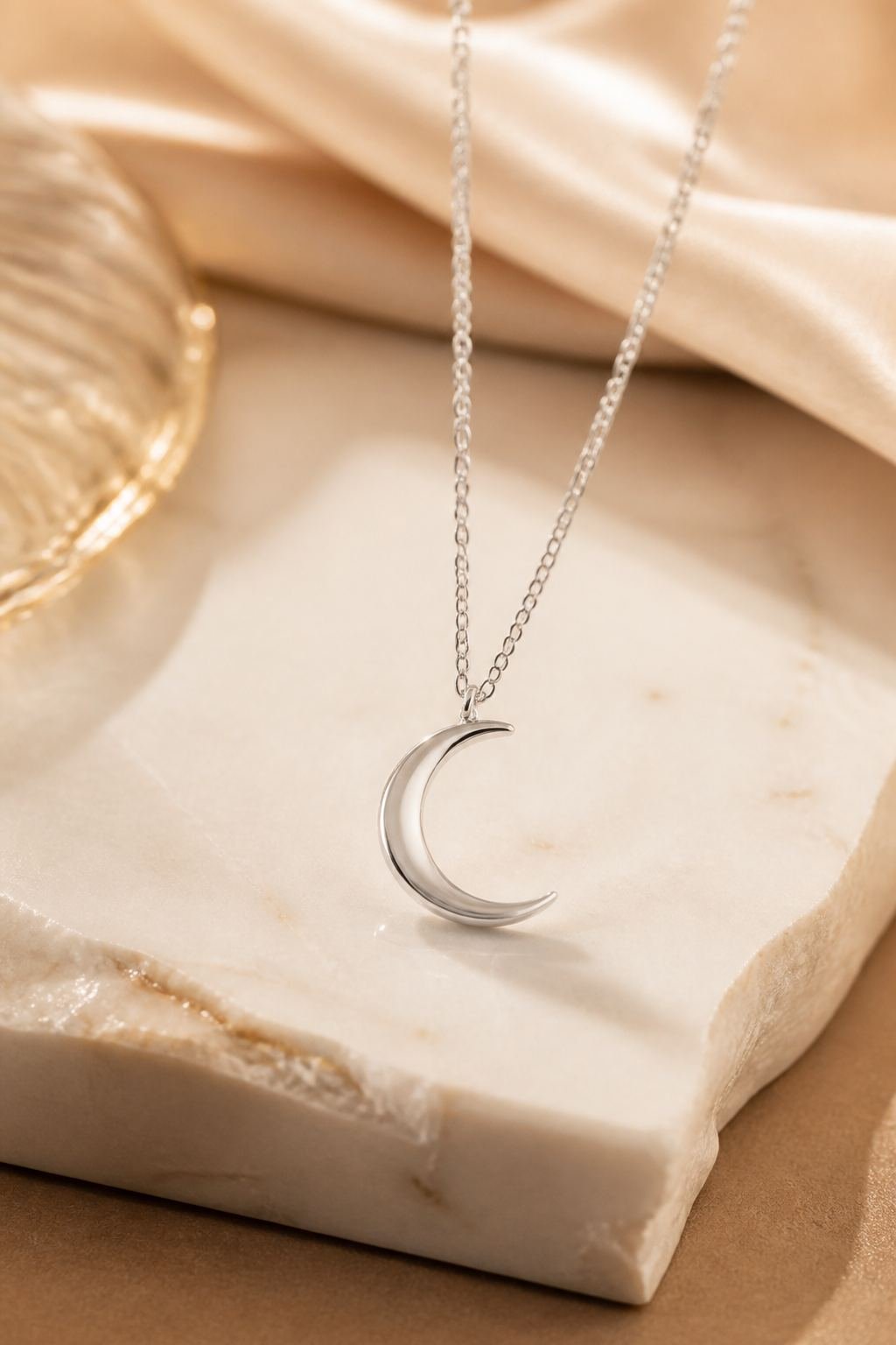 Sterling silver crescent pendant on marble
